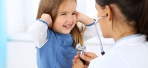 Doctor examining a little girl by stethoscope