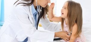 Doctor examining a little girl by stethoscope